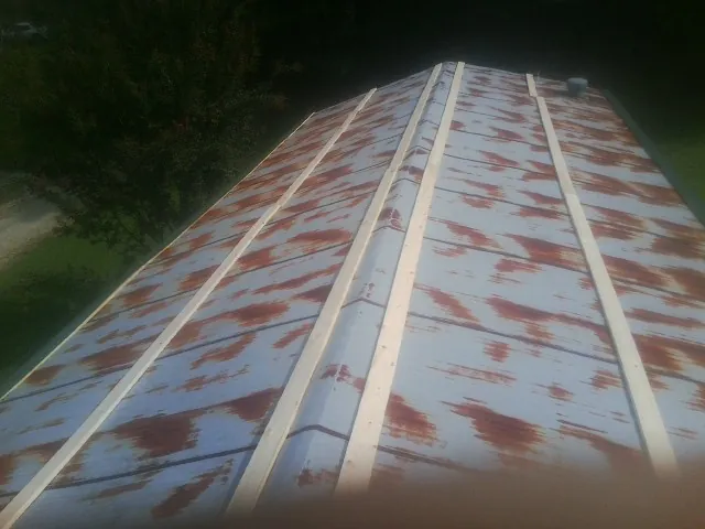 Rusted metal roof panels with new wood purlins before replacement — Storm Damage Roof Repair in Mc Kenney by Roofing Brothers