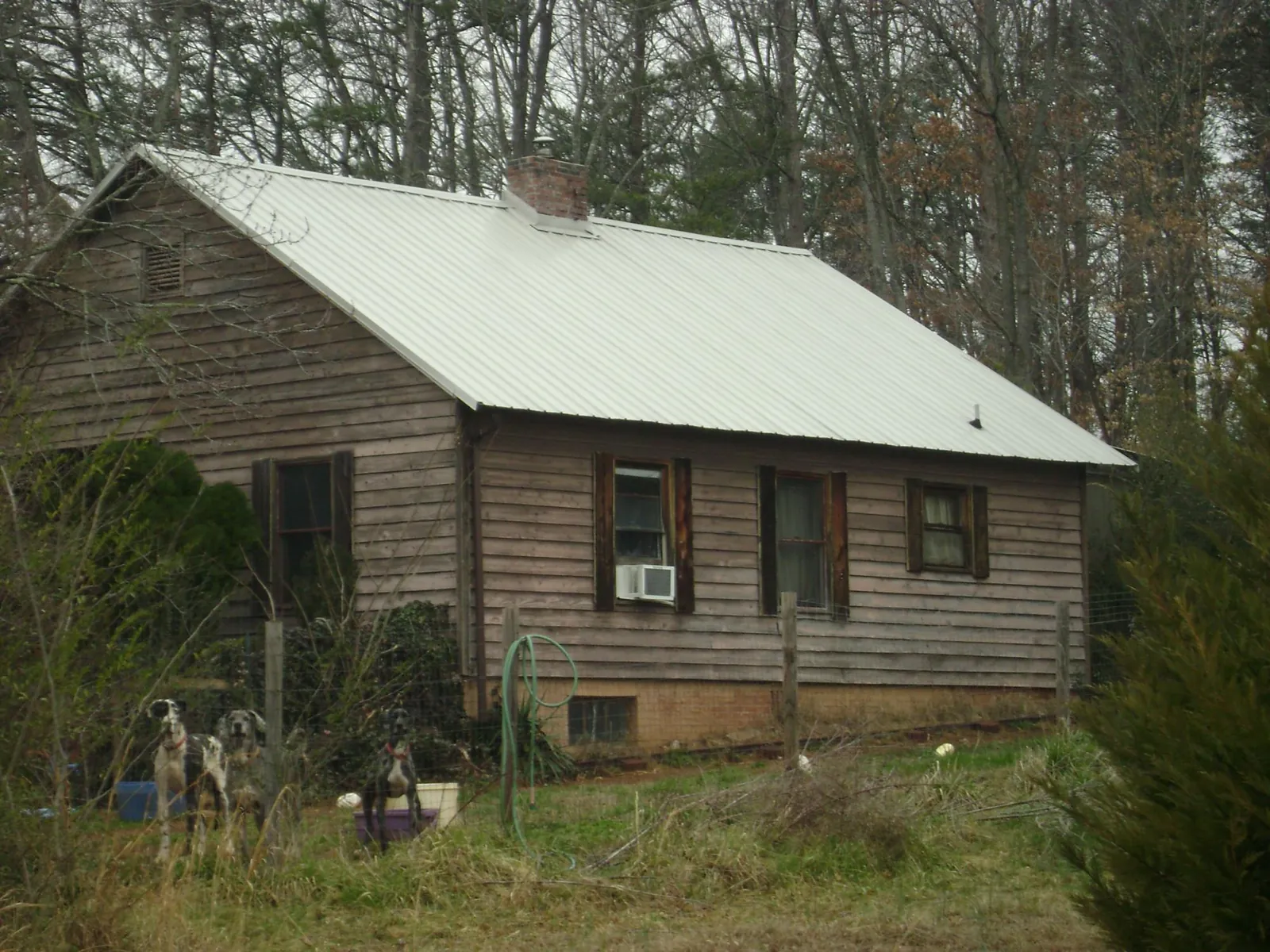 White metal roof on an old wood sided farmhouse, from a Metal Roof Installation job in Mc Kenney